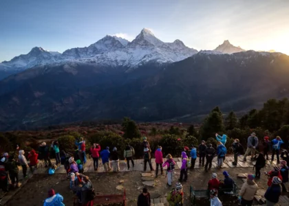 A crowd gathers at Poon Hill to witness the breathtaking sunrise over the Himalayas