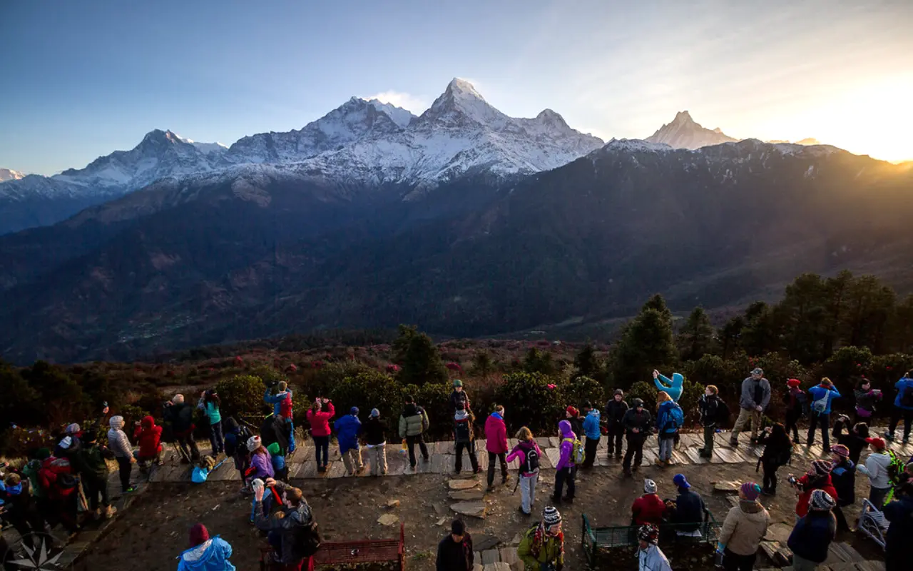 A crowd gathers at Poon Hill to witness the breathtaking sunrise over the Himalayas